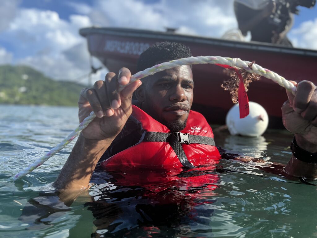 Nicholas Kee and his team holding a sea weed